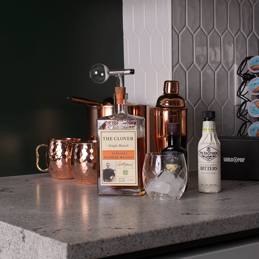 Saints Pour and old fashion ingredients on top of a mini bar